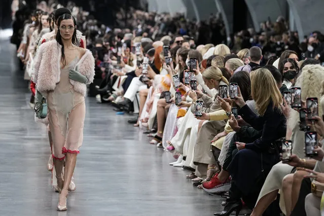 Bella Hadid, leads other models, as they wear creations as part of the Fendi Fall/Winter 2022-2023 fashion collection, as guests record the show on their cell phones during the Fashion Week in Milan, Italy, Wednesday, February 23, 2022. (Photo by Antonio Calanni/AP Photo)