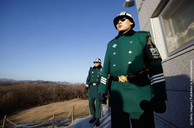 South Korean soldiers look at North Korea from an observation post