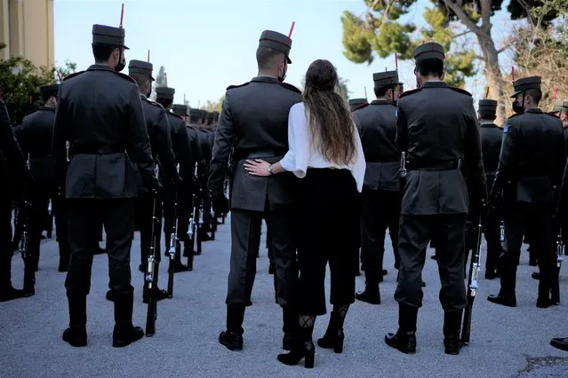 A girl hugs his brother before the military parade commemorating Greek Independence Day in Athens, Greece, Friday, March 25, 2022. The national holiday on March 25 marks the start of Greece's 1821 war of independence against the 400-year Ottoman rule. Greece signed agreements Thursday with France and two French contractors worth some 4 billion euros ($4.4 billion) to purchase three navy frigates and six additional Rafale fighter jets, as Athens continues to strengthen its armed forces in response to tension with neighbor Turkey. (Photo by Thanassis Stavrakis/AP Photo)