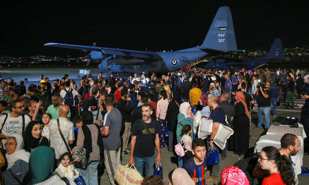 People evacuated from Sudan arrive at a military airport in Amman on April 24, 2023. Foreign countries rushed to evacuate their nationals from Sudan as deadly fighting raged into a second week between forces loyal to two rival generals. (Photo by Khalil Mazraawi/AFP Photo)