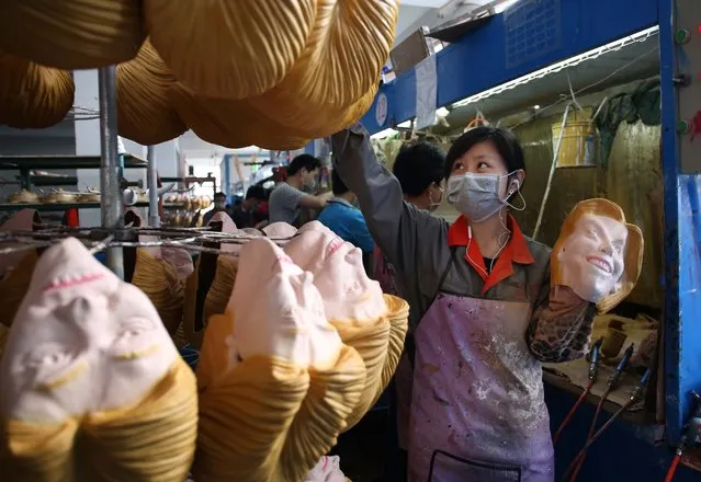 A picture made available on 27 May 2016 shows a woman working on latex masks of US presidential candidate Hillary Clinton at a factory in Pujiang county, in east China's Zhejiang province, China, 18 May 2016. The orders for the masks of Donald Trump and Hilary Clinton both exceed 500,000 pieces from the factory, expected to arrive on US soil soon. (Photo by Ge Yuejin/EPA)