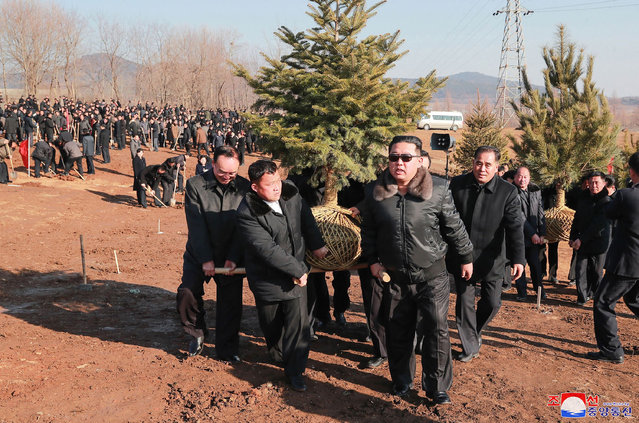This picture taken on March 2, 2022 and released from North Korea's official Korean Central News Agency (KCNA) on March 3 shows North Korean leader Kim Jong Un (C) attending the tree-planting ceremony with the participants in the 2nd Conference of Secretaries of Primary Committees of the WPK on the Tree-planting Day in Pyongyang. (Photo by KCNA via KNS/AFP Photo)