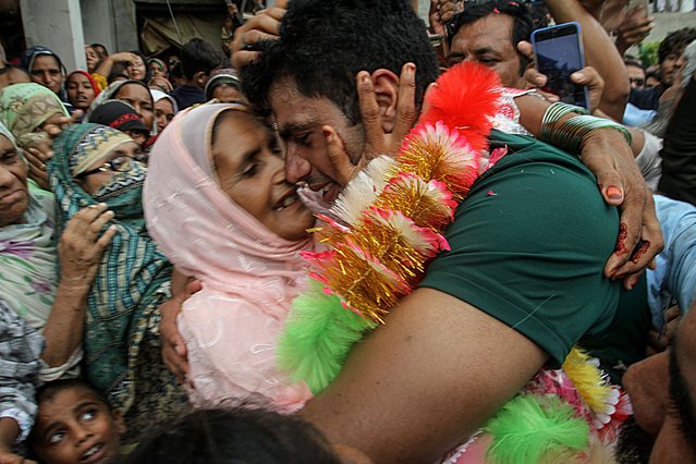 Arshad Nadeem (R), Pakistan's javelin gold medallist at the Paris 2024 Olympic Games, hugs his mother Raziah Parveen upon his arrival at his hometown in Mian Channu on August 11, 2024. (Photo by AFP Photo/Stringer)