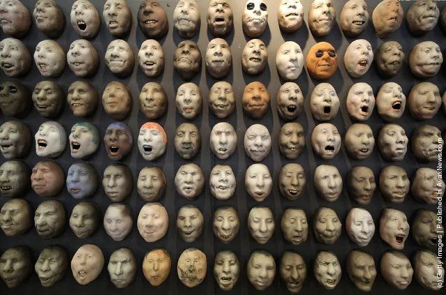 Pottery heads by artist Johan Thunell are displayed at The Affordable Art Fair