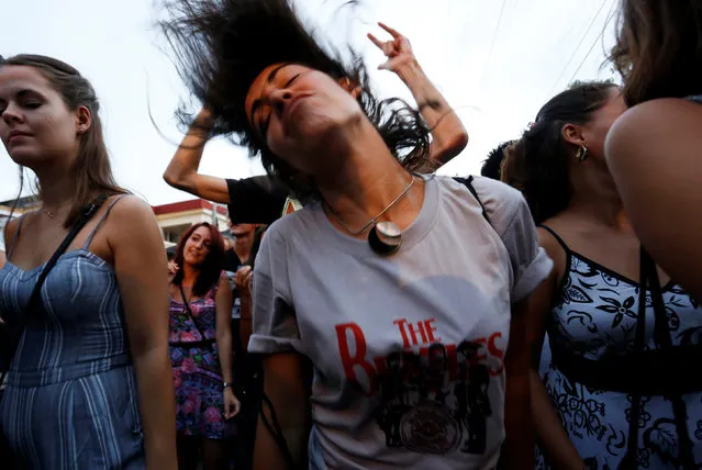 A woman dances during an open-air covers concert in celebration of the release of Beatles' landmark album “Sgt. Pepper's Lonely Hearts Club Band” 50 years ago, in Havana, Cuba June 1, 2017. (Photo by Reuters/Stringer)