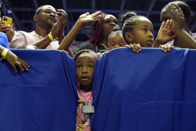 A child looks between crowd barriers watching Vice President Kamala Harris speak at a campaign rally in Savannah, Ga., August 29, 2024. (Photo by Jacquelyn Martin/AP Photo)