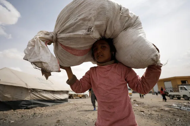 An internally displaced Syrian girl who fled Raqqa city carries a bag on her head inside a camp in Ain Issa, Raqqa Governorate, Syria May 2, 2017. (Photo by Rodi Said/Reuters)