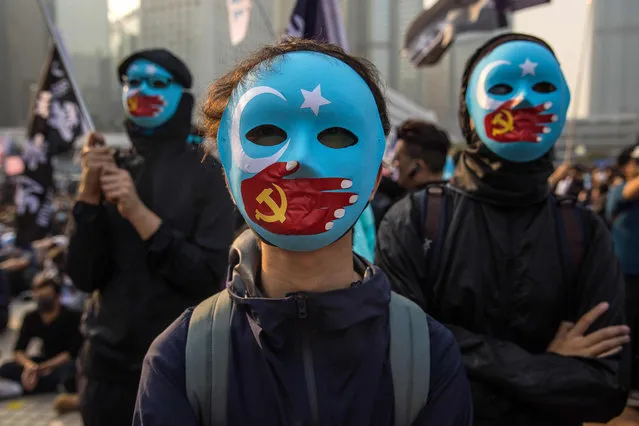 Protesters attend a rally in Hong Kong on December 22, 2019 to show support for the Uighur minority in China. Hong Kong riot police broke up a rally in solidarity with China's Uighurs on December 22 as the city's pro-democracy movement likened their plight to that of the oppressed Muslim minority. (Photo by Dale de la Rey/AFP Photo)