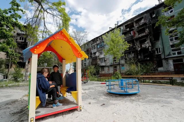 Children gather at a playground during Ukraine-Russia conflict in the southern port city of Mariupol, Ukraine May 11, 2022. (Photo by Alexander Ermochenko/Reuters)