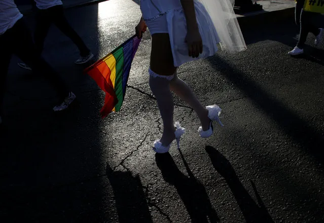 A participant holds a rainbow flag duing an annual Gay Pride Parade in Monterrey, Mexico June 18, 2016. (Photo by Daniel Becerril/Reuters)