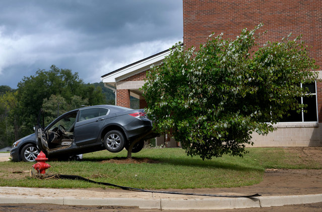 A vehicle is scene backed up onto a tree outside of the Old Fort Elementary School in the aftermath of Hurricane Helene on September 29, 2024 in Old Fort, North Carolina. According to reports, more than 60 people have been killed across the South due to the storm, and millions have been left without power. North Carolina has been approved for a Federal Major Disaster Declaration. (Photo by Melissa Sue Gerrits/Getty Images)