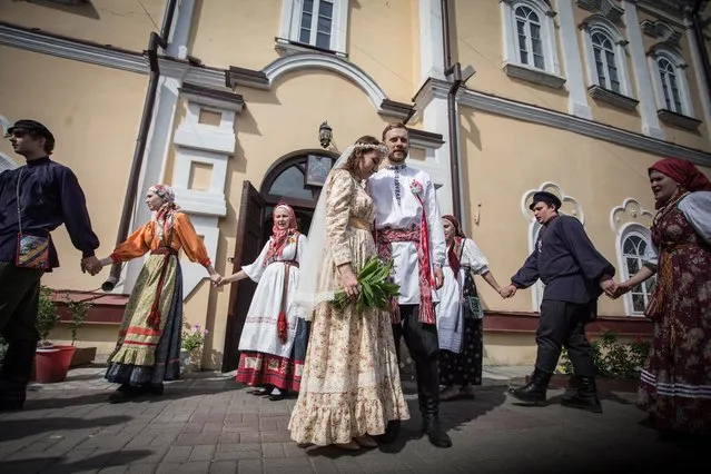 Bride Diana Khamitova with her groom Ilya Klinkin during their traditional wedding ceremony at the city’s local history museum in Tomsk, Russia on June 27, 2016. (Photo by Danila Shostak/Tass via Getty Images)