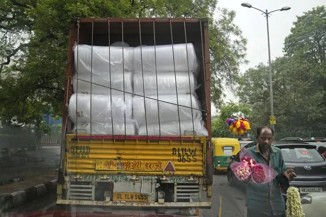 A commercial truck transports rolls of plastic used in packing in New Delhi, India, Thursday, June 30, 2022. (Photo by Manish Swarup/AP Photo)