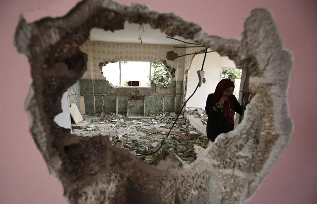 A woman checks the remains of the house of a Palestinian man, who killed three Jewish residents of a nearby Israeli settlement, after it was demolished by Israeli authorities in the village of Kobar, near Ramallah, in the occupied West Bank, on August 16, 2017. Israeli forces in the pre-dawn hours demolished the home of the Palestinian who stabbed to death three members of an Israeli family on July 21 in the Jewish settlement of Neve Tsuf, also known as Halamish. (Photo by Abbas Momani/AFP Photo)