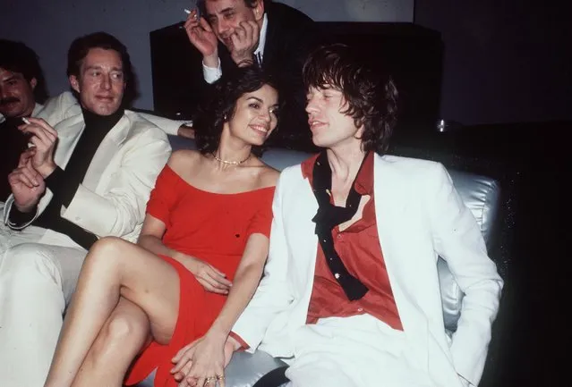 Mick Jagger looks unconcerned as his wife, Bianca, snuggles up to designer Halston (L) during Bianca's birthday bash at Studio 54 in the wee hours of the morning in New York, NY on May 3, 1977. (Photo by Richard Corkery/NY Daily News Archive via Getty Images)