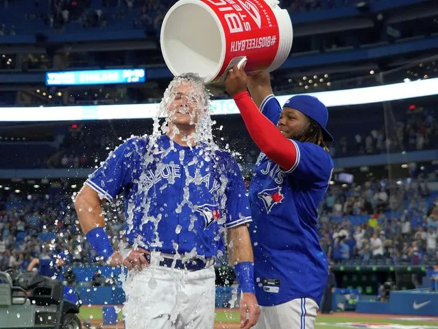 Matt Chapman #26 of the Toronto Blue Jays is doused with water by Vladimir Guerrero Jr. #27 following a game against the Kansas City Royals at Rogers Centre on July 15, 2022 in Toronto, Ontario, Canada. (Photo by John E. Sokolowski/USA TODAY Sports)