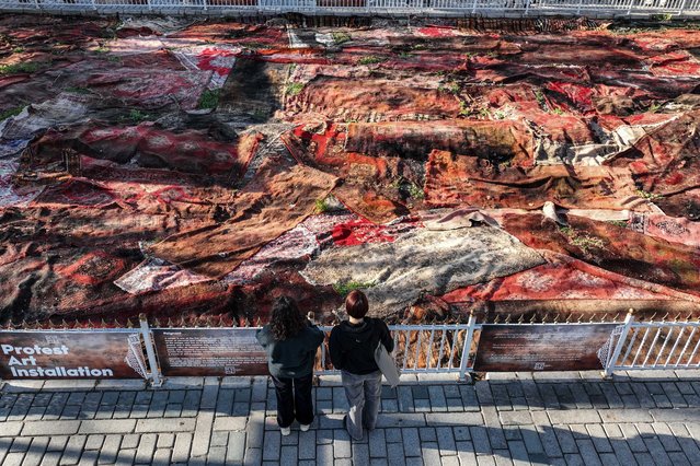 An aerial view of carpet art installation 'Poignant' placed in a plot near Hagia Sophia Grand Mosque in Istanbul, Turkiye on November 06, 2024. The installation draws the attention of visitors to the war in Gaza, as artists reference carpets as symbols of identity, collective memories and shared experiences. The carpets are used as silent witnesses to the destruction of war. (Photo by Cem Tekkesinoglu/Anadolu via Getty Images)