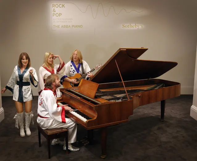 Actors of the ABBA show “Bjoern Again” perform on a piano at Sotheby's auction house in London, Thursday, August 27, 2015. A grand piano that featured on many of ABBA's biggest hits is going up for auction in London. Sotheby's is offering the instrument, owned by the Stockholm recording studio where the Swedish pop group often recorded. (Photo by Frank Augstein/AP Photo)