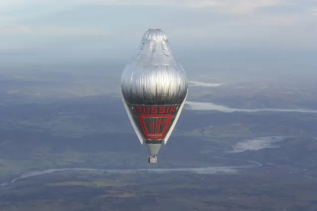 In this Tuesday, July 12, 2016 photo released Wednesday, July 20, 2016 by Morton, Russian adventurer Fedor Konyukhov floats at more than 6,000 meters (20,000 feet) above an area close to Northam in Western Australia state in his helium and hot-air balloon as he makes a record attempt to fly solo in a balloon around the world nonstop. (Photo by Oscar Konyukhov/Morton via AP Photo)