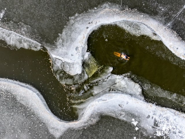 A winter swimming enthusiast braves cold to swim in partly frozen Hunhe River on December 18, 2024 in Shenyang, Liaoning Province of China. (Photo by Wang Ruizhong/VCG via Getty Images)