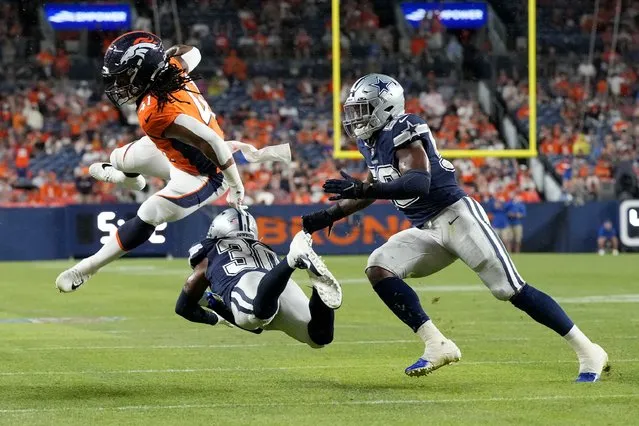 Denver Broncos safety Jamar Johnson (41) avoids the tackle of Dallas Cowboys cornerback DaRon Bland (30) during the second half of an NFL preseason football game, Saturday, August 13, 2022, in Denver. (Photo by David Zalubowski/AP Photo)
