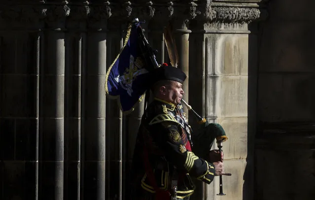 A piper plays outside St. Giles Cathedral, in Edinburgh, Scotland, Tuesday, September 13, 2022. King Charles III and Camilla, the Queen Consort, flew to Belfast from Edinburgh on Tuesday, the same day the queen’s coffin will be flown to London from Scotland. (Photo by Kai Pfaffenbach/Pool Photo via AP Photo)
