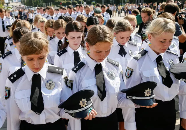 Police officers attend a ceremony to mark the 1st anniversary of a reformed police service, part of Interior Ministry reforms which introduced road, metro and foot police patrols, in Kiev, Ukraine August 4, 2016. (Photo by Gleb Garanich/Reuters)