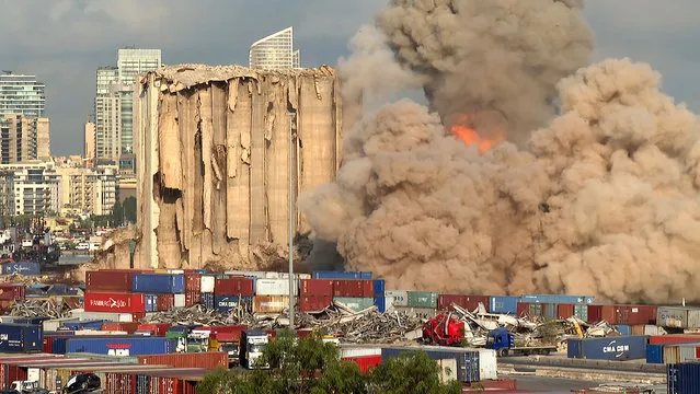 This grab from AFPTV footage shot on August 23, 2022 shows a smoke plume rising after the new collapse of the northern section of the grain silos at the port of Lebanon's capital Beirut, which were previously partly destroyed by the 2020 port explosion. Eight more grain silos at Beirut port toppled on August 23, succumbing to damage from a devastating 2020 explosion in the third such collapse in a month, AFP correspondents reported. The remaining southern block is more stable and not at imminent risk of collapse, said French civil engineer Emmanuel Durand, who has installed sensors on the silos. (Photo by Dylan Collins/AFPTV via AFP Photo)