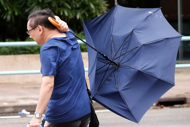 A man struggles with an umbrella while walking against strong wind as Typhoon Nida hits Hong Kong, China August 2, 2016. (Photo by Tyrone Siu/Reuters)