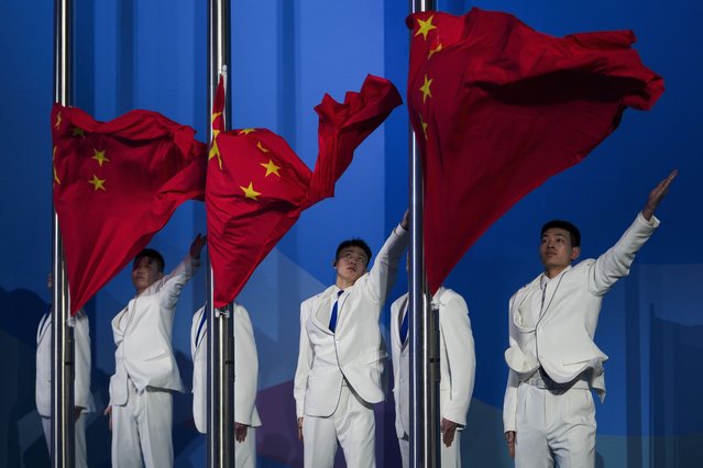 Soldiers unfurl the China national flags during the medal ceremony for the Women's Freeski Slopestyle at the 9th Asian Winter Games in Yabuli in northeast China's Heilongjiang province on Tuesday, February 11, 2025. (Photo by Andy Wong/AP Photo)
