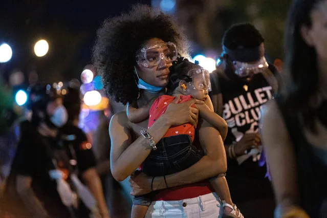 One and a half year old Bonita is held by her mother during a Black Lives Matter protest near the White House in Washington D.C., U.S. on June 23, 2020. Trump tweeted that he authorized the Federal government to arrest any demonstrator caught vandalizing U.S. monuments, with a punishment of up to 10 years in prison. (Photo by Rex Features/Shutterstock)