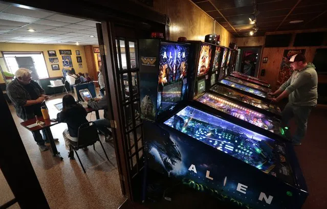 Matt Koenen played pinball at West County Lanes in Ellisville, Mo., as voters used the bowling alley's party room next door to cast their ballots, Tuesday, November 8, 2022. (Photo by Robert Cohen/St. Louis Post-Dispatch via AP Photo)