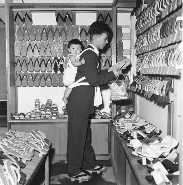 Before World War II, caring for children was the Japanese wife's duty. Here, a modern father and baby daughter shop for shoes, August 18, 1959. (Photo by AP Photo)