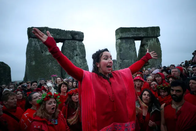 Revellers celebrate as the sun rises during the winter solstice at Stonehenge on Salisbury Plain in southern England, Britain, December 22, 2017. (Photo by Hannah McKay/Reuters)
