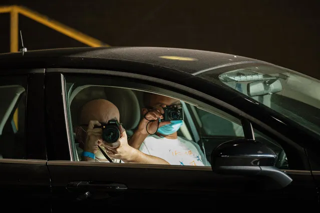 Law enforcement agents photograph protestors from an unmarked car during another anti secret police protest, Wednesday, July 29, 2020 in Cleveland, Ohio. According to local media reports, 25 Federal officers and agents have been dipatched to the city on order from President Donald Trump as part of his “Operation Legend” Federal crime intiative. (Photo by Andrew Dolph/Zuma Wire/Rex Features/Shutterstock)