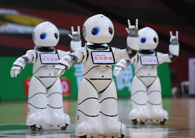 Robotic cheerleaders perform during a break of the round of 12 match between Zhejiang Lions and Fujian Sturgeons at the 2019-2020 Chinese Basketball Association (CBA) league playoffs in Qingdao, east China's Shandong Province, July 31, 2020. (Photo by Xinhua News Agency/Rex Features/Shutterstock)