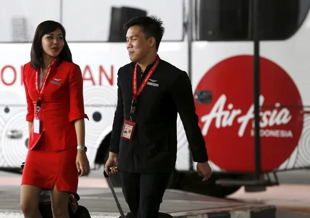 AirAsia flight crew members talk as they walk in the Soekarno-Hatta Airport in Jakarta, in this July 8, 2015 file photo. Founders of Asia's No.1 budget carrier AirAsia Bhd are sounding out investors to take the company private in a management-led buyout, after its shares took a beating this year following a critical research report, people familiar with the matter said. (Photo by Reuters/Beawiharta)
