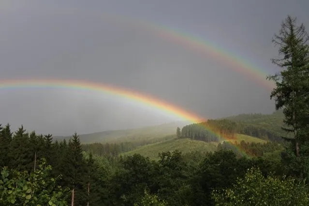 In this photo taken on Wednesday, July 29, 2015, two rainbows are pictured over a valley near Kreuztal-Krombach, western Germany. (Photo by Joerg Taron/DPA via AP Photo)