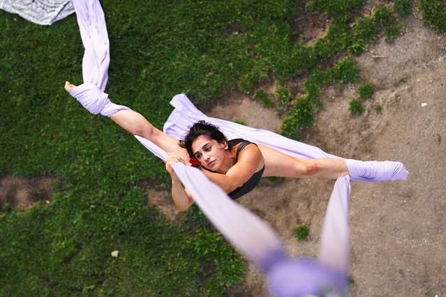 Agustina, 25, practices aerial silks at Madrid Rio during a hot day in Madrid, Spain on May 31, 2025. (Photo by Ana Beltran/Reuters)