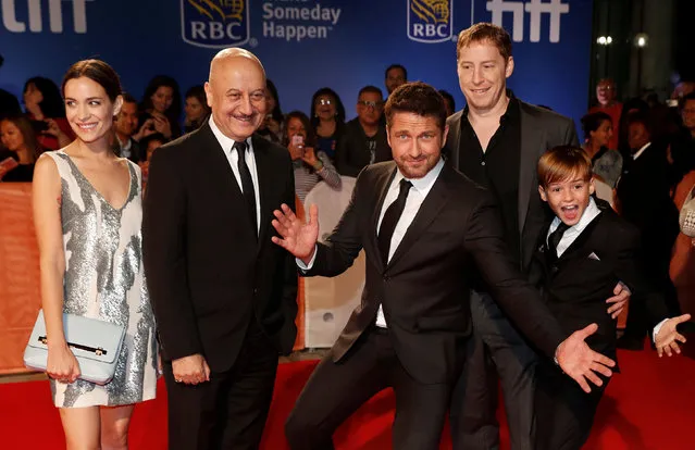 Actors Kathleen Munroe (L), Anupam Kher, Gerard Butler (C), and Maxwell Jenkins (R), pose with director Mark Williams (2nd R), as they arrive on the red carpet for the film “The Headhunter’s Calling” during the 41st Toronto International Film Festival (TIFF), in Toronto, Canada, September 14, 2016. (Photo by Mark Blinch/Reuters)