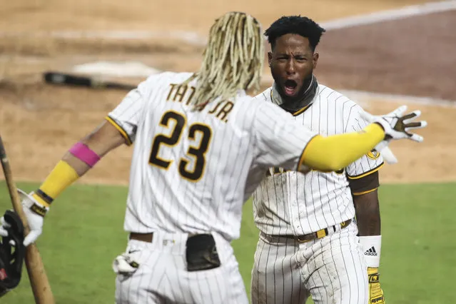 San Diego Padres' Jurickson Profar, right, reacts after scoring on a fielder's choice in the seventh inning of a baseball game against the Los Angeles Dodgers, Monday, September 14, 2020, in San Diego. (Photo by Derrick Tuskan/AP Photo)