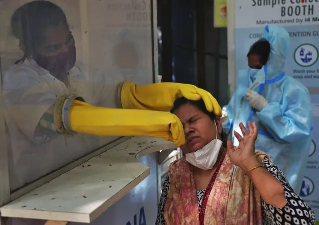 A health worker collects a nasal swab sample to test for COVID-19 in Hyderabad, India, Tuesday, September 22, 2020. The nation of 1.3 billion people is expected to become the coronavirus pandemic's worst-hit country within weeks, surpassing the United States. (Photo by Mahesh Kumar A./AP Photo)