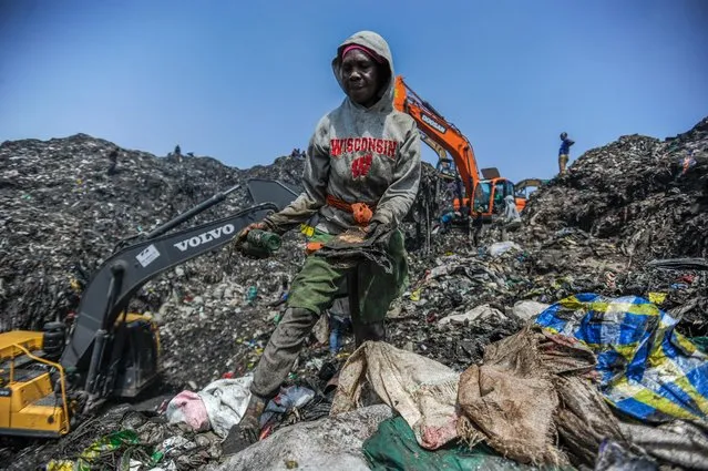 A woman collects items that are still intact to sell among waste material at Dandora, Nairobi's main dump site, in Kenya on January 14, 2023. Covering an area of 30 acres, the Dandora is the livelihood of many Kenyans from Korogocho, Baba Ndogo and Dandora regions, although it poses serious health threats. (Photo by Gerald Anderson/Anadolu Agency via Getty Images)