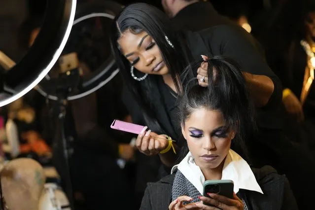 A model has her hair done backstage before modeling the Sergio Hudson collection during Fashion Week, Saturday, February 11, 2023, in New York. (Photo by Mary Altaffer/AP Photo)