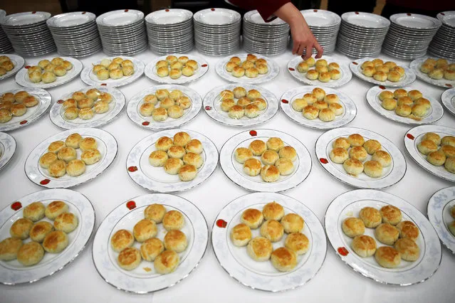 Attendants get ready to serve food before the start of a reception to celebrate National Day at the Great Hall of the People in Beijing, China September 30, 2016. (Photo by Damir Sagolj/Reuters)