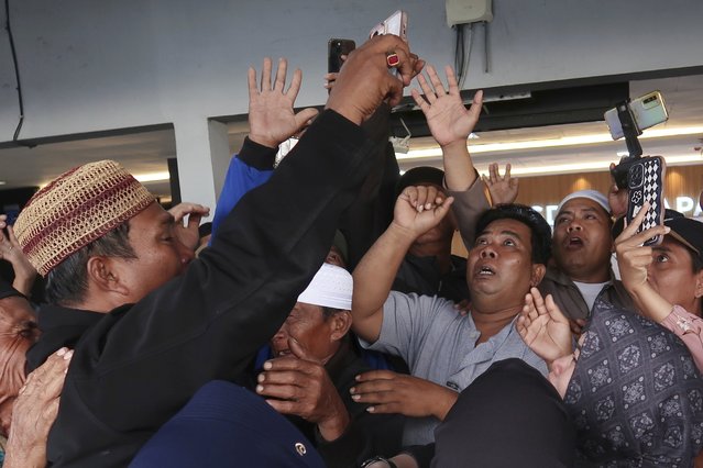 Relatives react as they have a video call with a survivor from a ferry that sank near the resort island of Bali, at Ketapang Port in Bayuwangi, East Java, Indonesia, Thursday, July 3, 2025. (Photo by Andur/AP Photo)