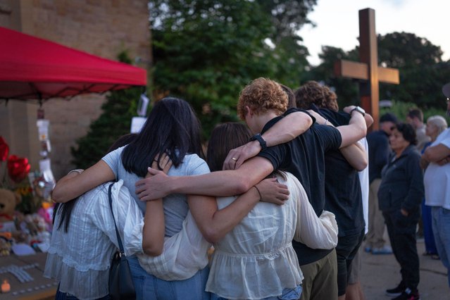 People gather at a memorial for victims of yesterday's shooting in front of Annunciation Catholic Church on August 28, 2025 in Minneapolis, Minnesota. A gunman fired through the windows of the church while students were sitting in pews during a Catholic school Mass, killing two children and injuring at least 17 others. The gunman reportedly died at the scene from a self-inflicted gunshot wound, according to police. (Photo by Scott Olson/Getty Images)
