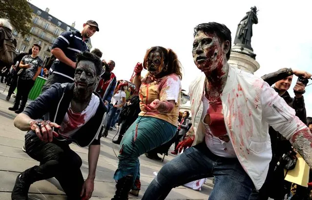 People dressed as zombies participate in a walk for World Zombie Day 2016 in Paris, France, 08 October 2016. More than 50 cities worldwide participate in the worldwide horror festival which is held in an effort to relieve hunger and homelessness. (Photo by Noemi Gago/SIPA Press)