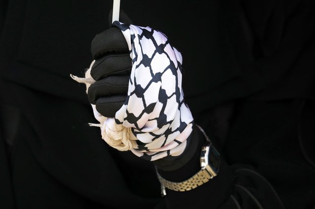 A protester has their hand wrapped in a Palestinian scarf during a rally in support of Gaza, in Sana'a, Yemen, 17 September 2025. Hundreds of protesters rallied in Sana'a in solidarity with Gaza, voicing their opposition to Israeli attacks and occupation. (Photo by Yahya Arhab/EPA)