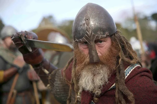 A re-enactor poses for a portrait before a re-enactment of the Battle of Hastings, commemorating the 950th anniversary of the battle, in Battle, Britain October 15, 2016. (Photo by Neil Hall/Reuters)